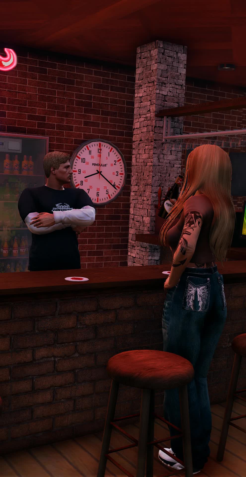 A bartender behind the bar talking to a customer holding a bottle