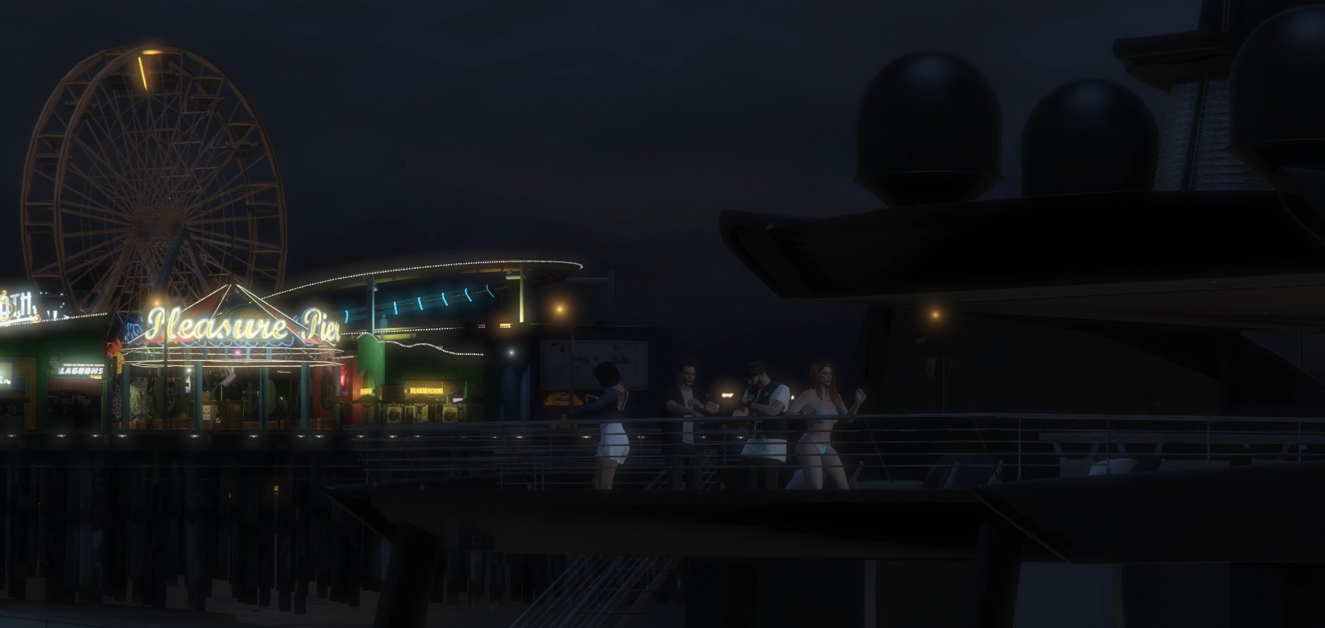 The Pleasure Pier lit up at night, ferris wheel and neon sign glowing, players talking at the railing